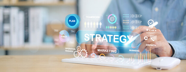 Business strategy and digital marketing planning concept. Person typing on keyboard with data analytics, growth charts, and teamwork icons representing planning and success.