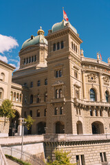 Fototapeta premium Bundeshaus federal palace in bern switzerland with flag