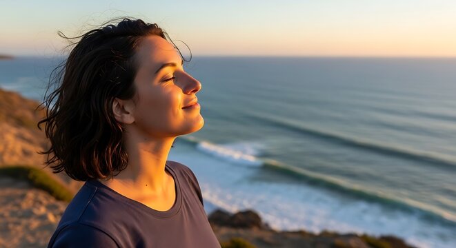 Young Woman Relaxing on Cliff Edge Near Ocean During Sunset - Powered by Adobe
