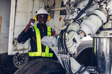 Aircraft workers checking airplane. Ground personnel at the airport check the hydraulic system of the landing gear of the aircraft