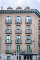 Symmetrical Facade of Traditional Brick Building with Green Shutters