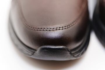 Close-up of a brown leather shoe on a clean surface