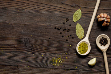 spices in spoon on wooden table top view