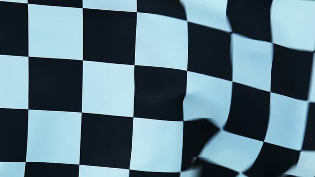Full frame of checkered flag waving, slow motion video