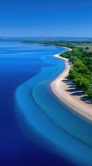 Lush Green Peninsula Meets Crystal Clear Blue Ocean Waters on a Sunny Day Aerial View of a Tropical Coastline