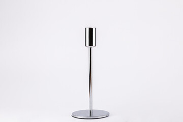 Front view of silver metal candle holder on white background, minimalist and contemporary style with copy space. Concept of modern elegance and home decor