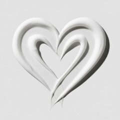 Abstract close-up shot of a white thick cream or lotion swirl in the shape of a heart on a light gray background