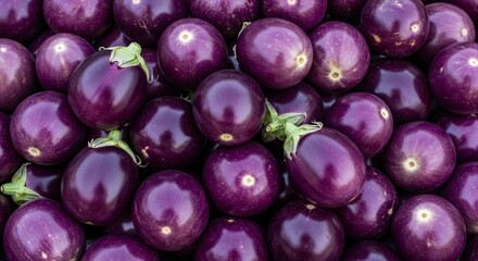 Close-up of a Vibrant Pile of Fresh Purple Eggplants