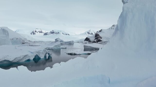 Aerial view flying over a glacial meltwater lake in antarctica