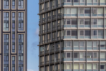 Fototapeta premium Striking Contrast Between Two Modern High-Rise Building Facades Side-by-Side
