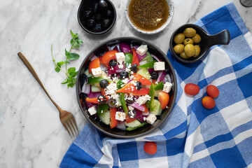 A vibrant overhead shot of a fresh Greek salad with various ingredients