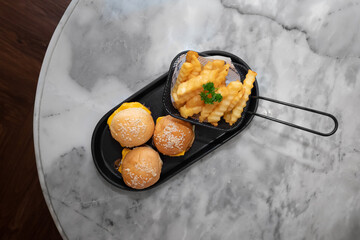 Delicious appetizer with french fries on a tray 