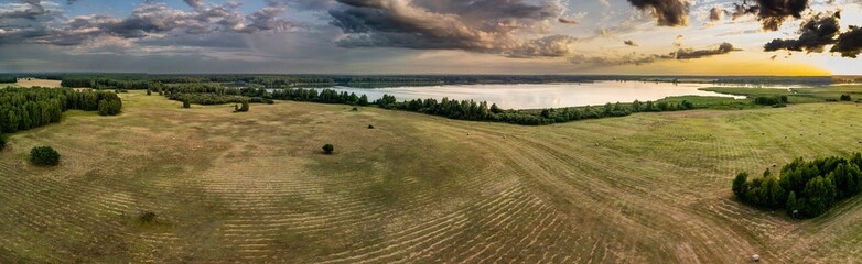 Panoramic aerial view of Stary Staw in the Barycz Valley, Poland, at sunset with meadows and surrounding forests