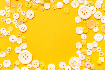 Frame made of different buttons on yellow background