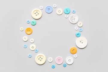 Frame made of different buttons on grey background