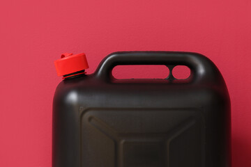 Black plastic canister on red background