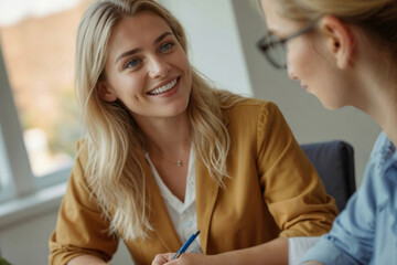 Happy female psychologist talks with a client in an office