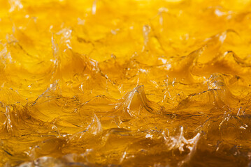 Yellow industrial grease glossy, fluid texture with organic patterns, reflections and mechanical energy