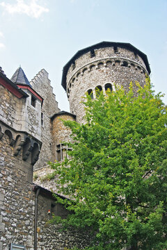 Stolberg Castle tower with machicolation rising above green trees. Symbol of medieval fortress architecture, historic stone fortification, German cultural heritage, and iconic Rhineland landmark.