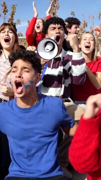 Group of excited fans celebrating and cheering a victory in a stadium