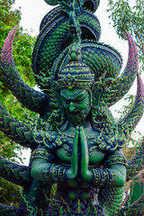 Background of Thailand's Chonburi religious attractions (Wat Khao Phra Khru viewpoint), with beautiful Buddha and Phaya Naga statues, tourists always come to make merit and take pictures at night.