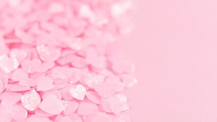 Soft focus image of pink heart-shaped candy scattered on a light pink surface, offering visual delight - Powered by Adobe