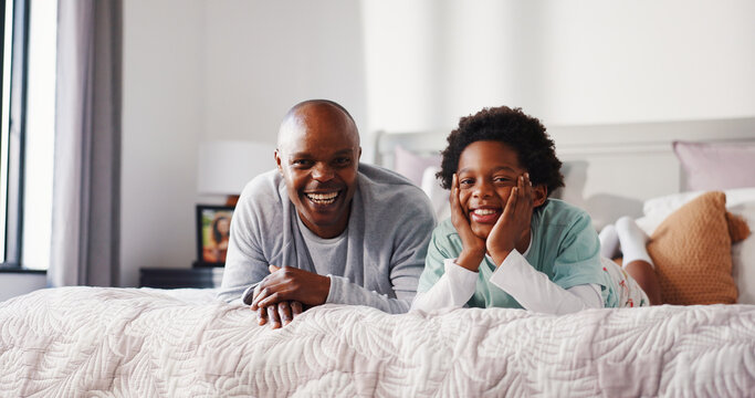 Portrait, father and happy child relax on bed for care, bonding together and laugh in morning. African family, boy and dad in bedroom with smile, funny joke or development with single parent in home - Powered by Adobe