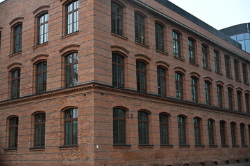 Renovated stylish red brick building with muntin windows on the corner
