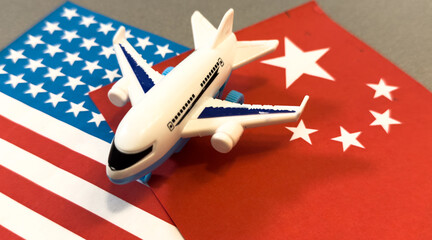 Flag of China with passport and toy airplane on wooden background. Flight travel concept.