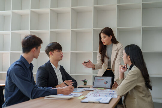 Young business team discussing financial strategy in meeting - Powered by Adobe
