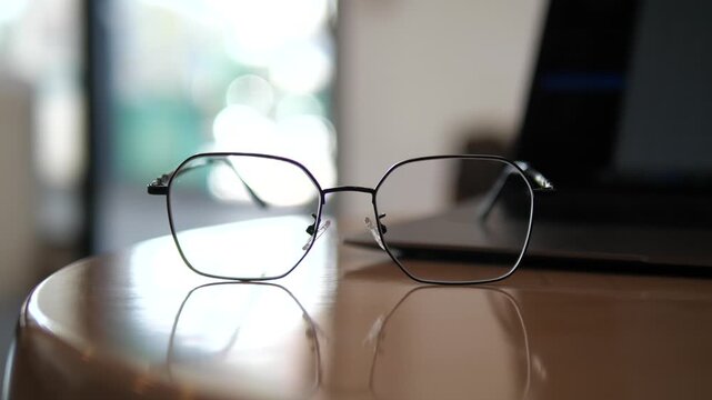 Eyeglasses on laptop with blurred background &ndash; concept of work, study, focus, and lifestyle in cozy natural light