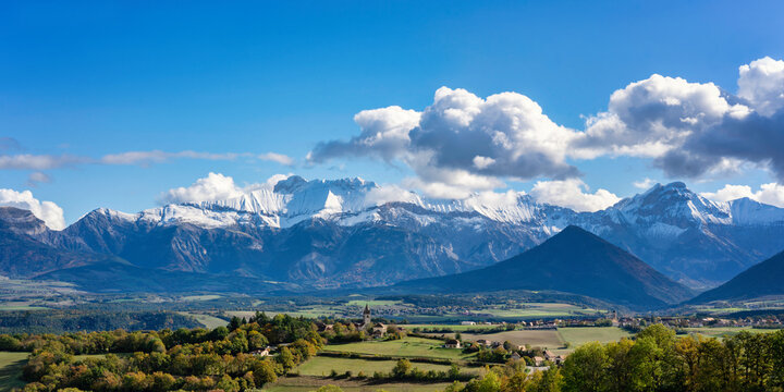 Percy village in a valley with snow capped Alps mountains