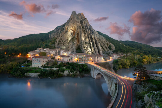 Sisteron village houses illuminated under Rocher de la Baume