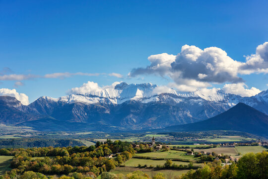 Percy village in a valley with snow capped Alps mountains