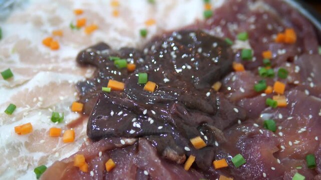 Raw mixed pork slices with liver and vegetables prepared for Thai hot pot (Jim Jum)