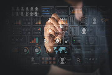 Hand with stylus interacting with multiple holographic dashboards for real time data analytics business monitoring and decision making