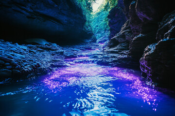 canyon river glowing under bioluminescent light, turning the waters into surreal, glowing stream