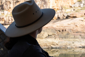 Traveler observes river gorge landscape