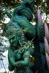 Background of Thailand's Chonburi religious attractions (Wat Khao Phra Khru viewpoint), with beautiful Buddha and Phaya Naga statues, tourists always come to make merit and take pictures at night.