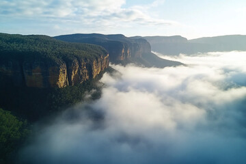 cinematic aerial view of dense mist swirling around mountaintops and valleys