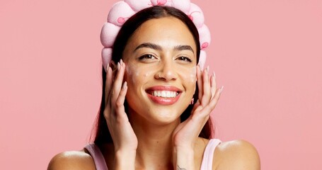 Portrait, woman and sunscreen for beauty in studio for hydration, healthy skin and collagen. Smile,...