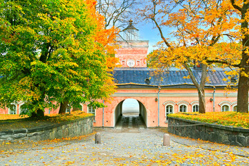 The pink building of Jetty Barracks, entrance to Iso Mustasaari, Suomenlinna, Finland on a day of autumn.
