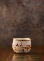 Traditional, handcrafted ceramic on wooden background. Soft focus. Copy space.