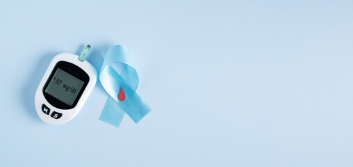 Glucometer on light blue background, crossed awareness ribbon, diabetes background, medical poster design, global awareness campaign. World Diabetes Day background with copy space.