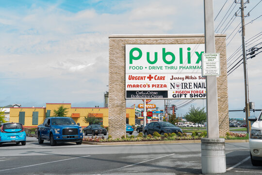 Pigeon Forge, Tennessee - July 3 2023: Roadside entry sign for  Publix supermarket urgent care Jersey Mike's Nail Salon Gift Shop