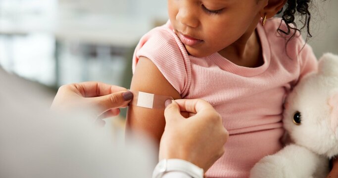 Medical, hands or child in clinic with plaster, first aid and trust in virus vaccine. Healthcare, wound or pediatrician in hospital with bandage, immunization shot or checkup in childhood development