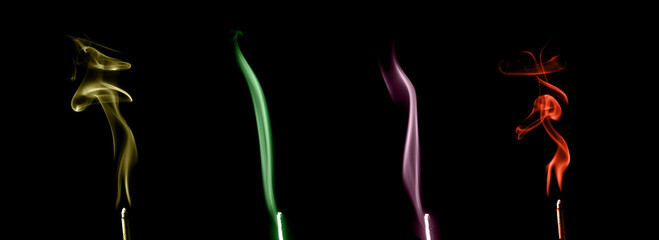 Fototapeta premium Colorful smoke waves in yellow, green, purple, and red on black background, showing soft motion and abstract energy art concept. Ideal for design, meditation, or creative backgrounds.
