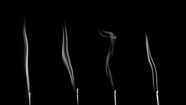 Minimalist image of incense smoke rising on a black background, creating smooth, elegant lines and calm atmosphere, perfect for meditation, relaxation, and abstract art design.