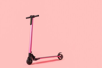 Modern electric scooter on pink background