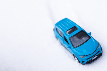 close up view of blue toy car with snow